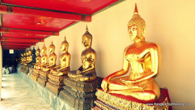 line of Buddha statues in subduing mara pose at Wat Po temple